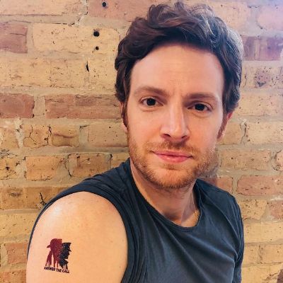 Nick Gehlfuss showing his answer the call tattoo